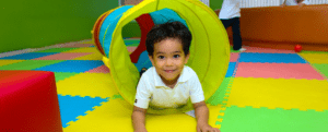 Happy child playing on mat| Birkdale Kindy Program