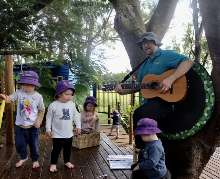 Educator singing to children in treehouse |Perfect Start Childcare